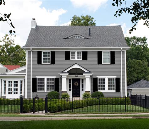 grey house with black shutters.